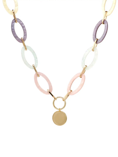 A statement necklace against a white background, featuring large, oval pastel multi colored resin links connected by gold-toned metal and a central, polished gold-toned circular pendant.