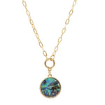 A short gold necklace featuring a natural abalone charm delicately dangled from a sleek and modern paperclip chain.
