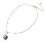 A short gold necklace featuring a natural abalone charm delicately dangled from a sleek and modern paperclip chain.