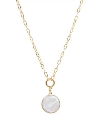 A close-up product image of the modern shell short necklace, displaying a round, iridescent mother of pearl shell pendant hanging from a gold-plated paperclip chain.