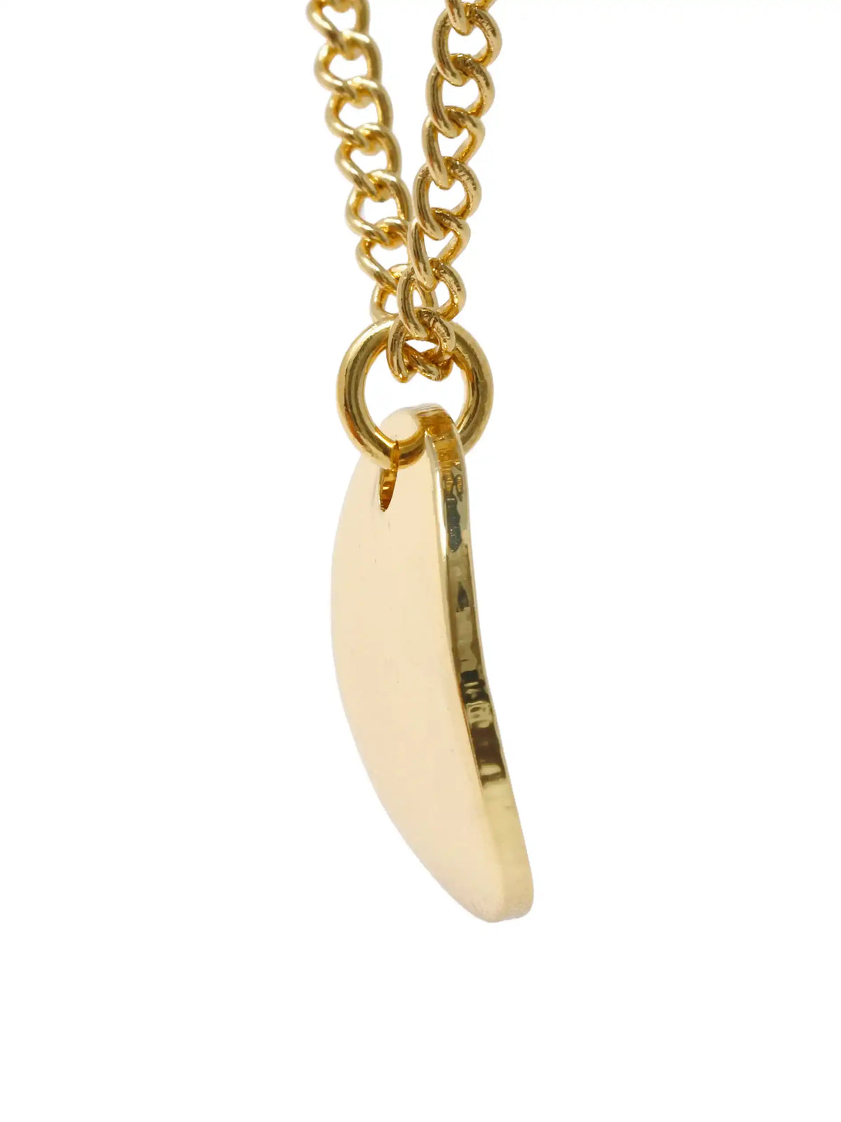 A gold chain necklace with a small, flat, crescent-shaped cream or off-white pendant, shown against a plain white background.
