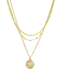 A layered gold necklace set featuring a main chain with a textured circular pendant, a middle chain with small gold beads, and a thin chain with bright neon yellow-green beads, all displayed on a clean white background.