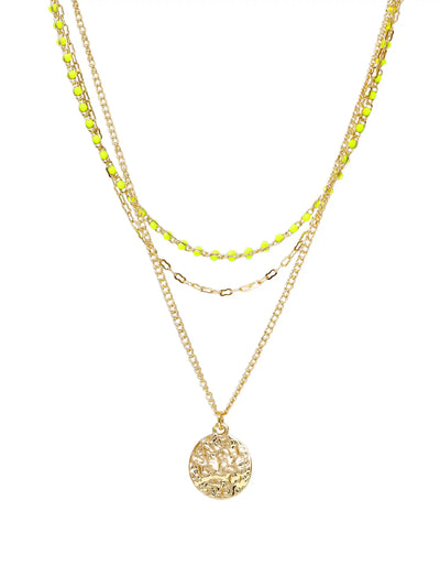 A layered gold necklace set featuring a main chain with a textured circular pendant, a middle chain with small gold beads, and a thin chain with bright neon yellow-green beads, all displayed on a clean white background.