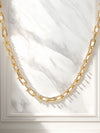 A bold gold link chain necklace with geometric links and polished bead connectors.