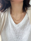 A bold gold link chain necklace with geometric links and polished bead connectors.
