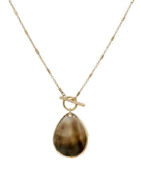 Gold necklace with a teardrop-shaped pendant on a white background