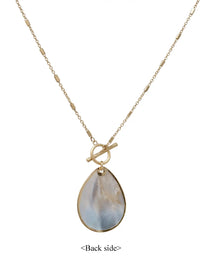 Gold necklace with a teardrop-shaped pendant on a white background
