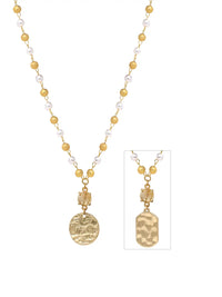 A gold and white beaded necklace with a textured gold pendant, shown on a white background with a smaller inset detail view of the pendant.