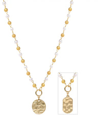 A gold and white bead necklace with a round textured gold medallion pendant, shown alongside an inset detail of a rectangular hammered gold pendant on a white background.