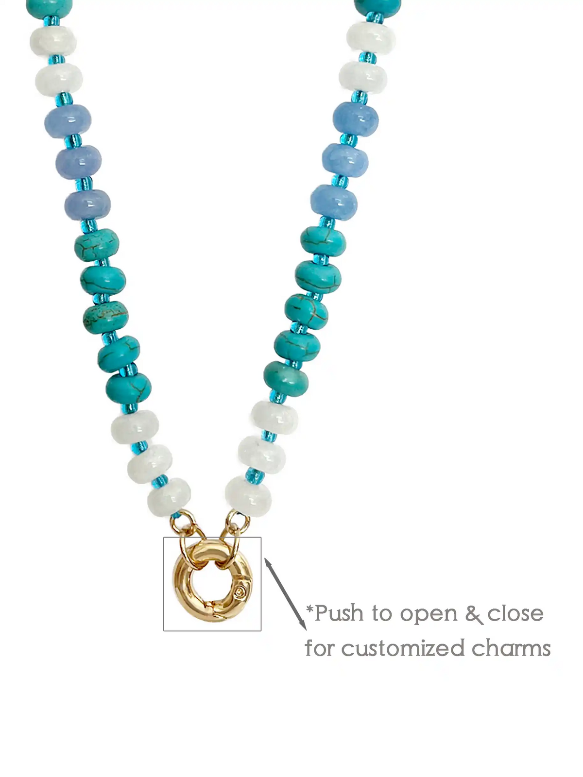 Blue beaded statement necklace with mixed white, turquoise, and dark blue beads, gold-tone clasp, and textured round coin pendant on a white background.