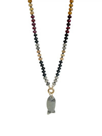 A beaded necklace featuring a double-strand chain of faceted beads in black, gray, white, tan, and burgundy, with a gold ring connector holding a polished gray stone pendant shaped like a fish, shown against a plain white background.