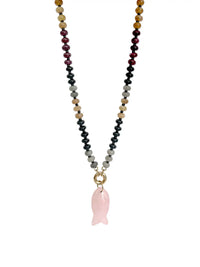 A beaded necklace featuring a central pink rose quartz fish-shaped pendant, suspended from a multi-colored strand of faceted beads in black, gray, tan, burgundy, and gold-toned tones, set against a plain white background.