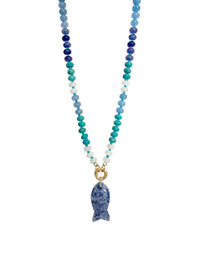 A beaded necklace featuring a gradient of blue, teal, and white beads, with a gold ring clasp and a blue sodalite stone fish pendant, shown against a plain white background.