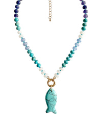 A beaded necklace featuring turquoise, teal, light blue, and white beads with a gold-tone fish-shaped pendant, displayed on a clean white background.