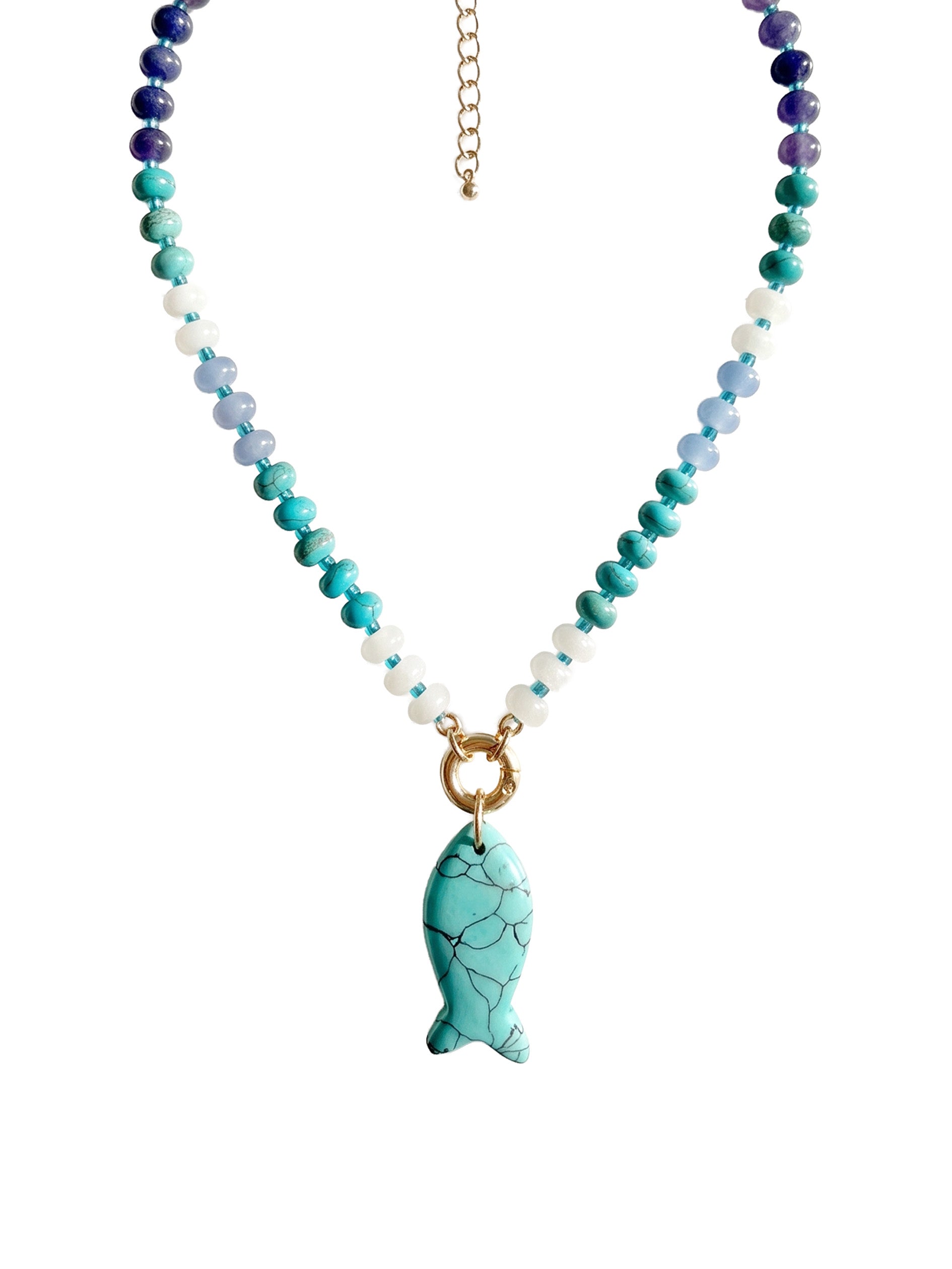 A beaded necklace featuring turquoise, teal, light blue, and white beads with a gold-tone fish-shaped pendant, displayed on a clean white background.