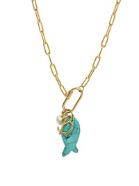 A gold paperclip chain necklace featuring a front-facing carabiner clasp that holds three distinct charms: a small round pearl, a gold script initial B, and a carved turquoise blue fish pendant.
