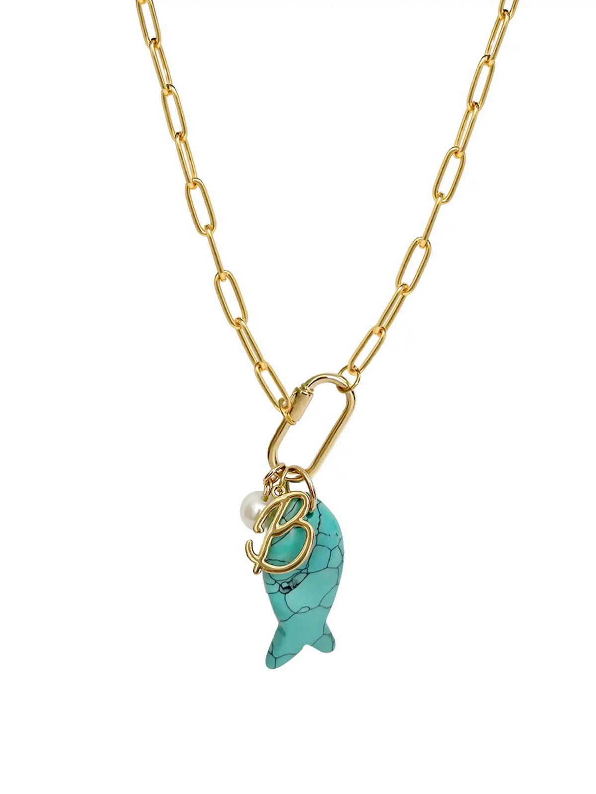 A gold paperclip chain necklace featuring a front-facing carabiner clasp that holds three distinct charms: a small round pearl, a gold script initial B, and a carved turquoise blue fish pendant.