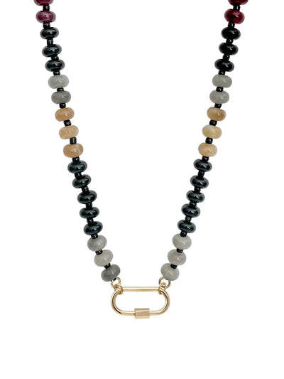 A natural semi-precious stone beaded necklace featuring black, gray, beige, and dark red round beads, with a gold-toned carabiner clasp, shown against a plain white background.