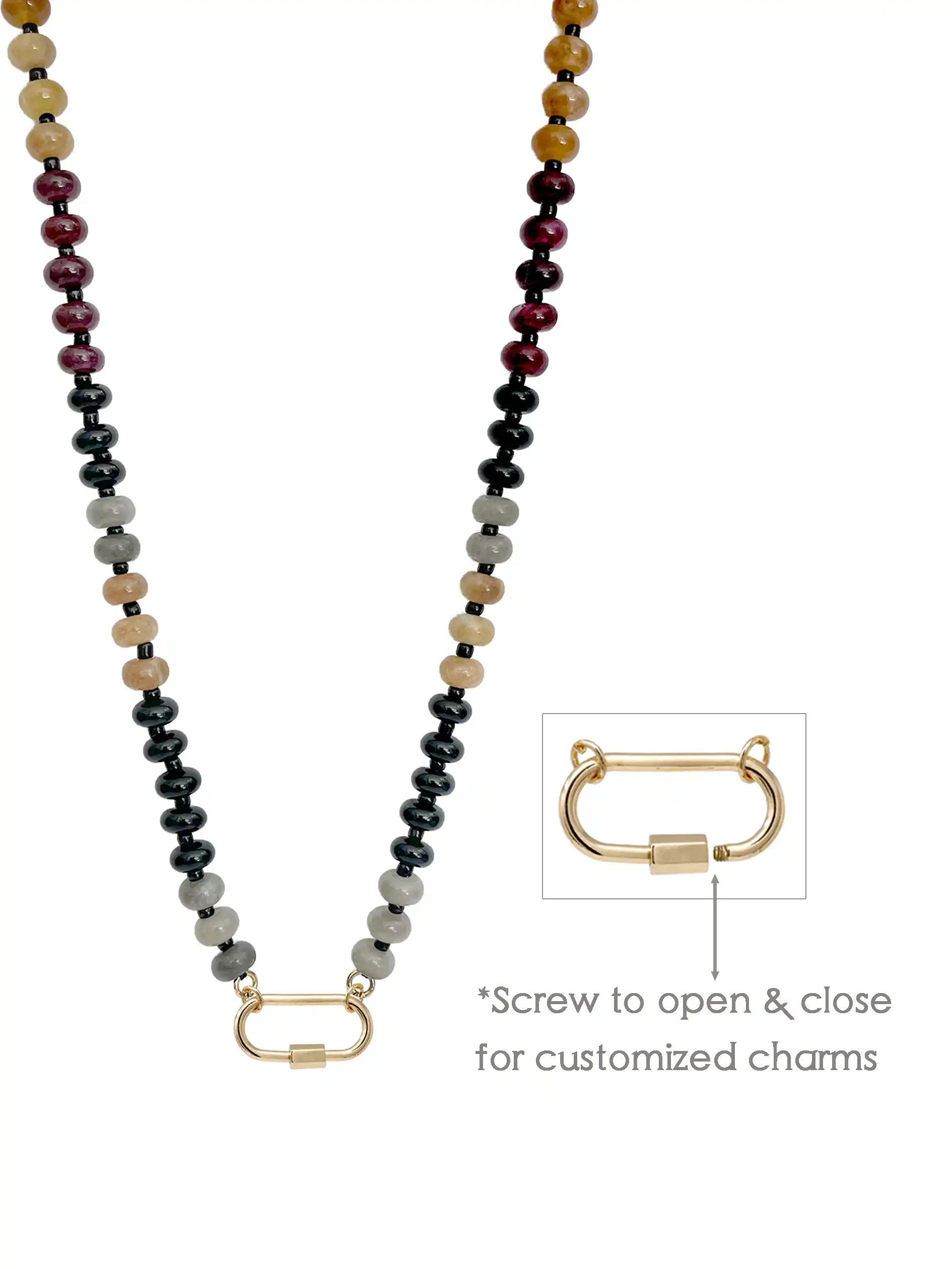 A semi-precious stone beaded necklace with dark gray, black, light gray, tan, and deep red beads, featuring a gold-toned carabiner. An inset diagram on the right shows a close-up of the clasp with text reading '*Screw to open & close for customized charms'.
