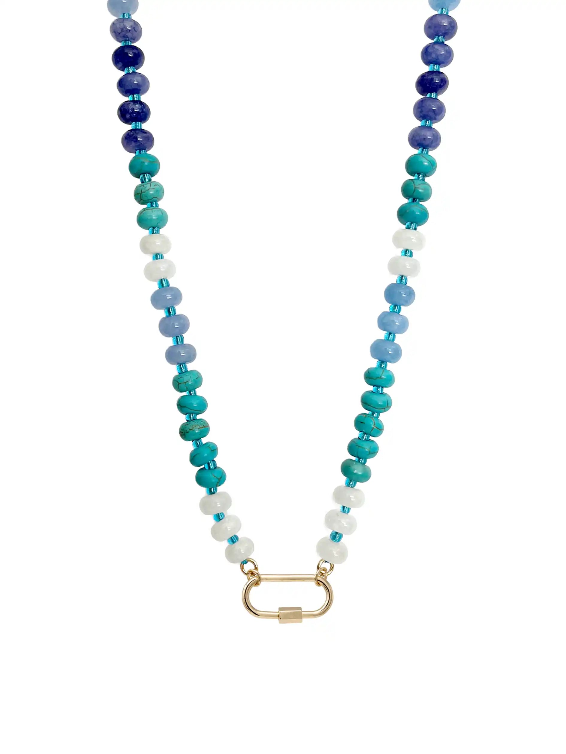 A semi-precious stone beaded necklace featuring a gradient of blue, teal, and white round beads, finished with a gold-toned carabiner clasp, shown against a plain white background.