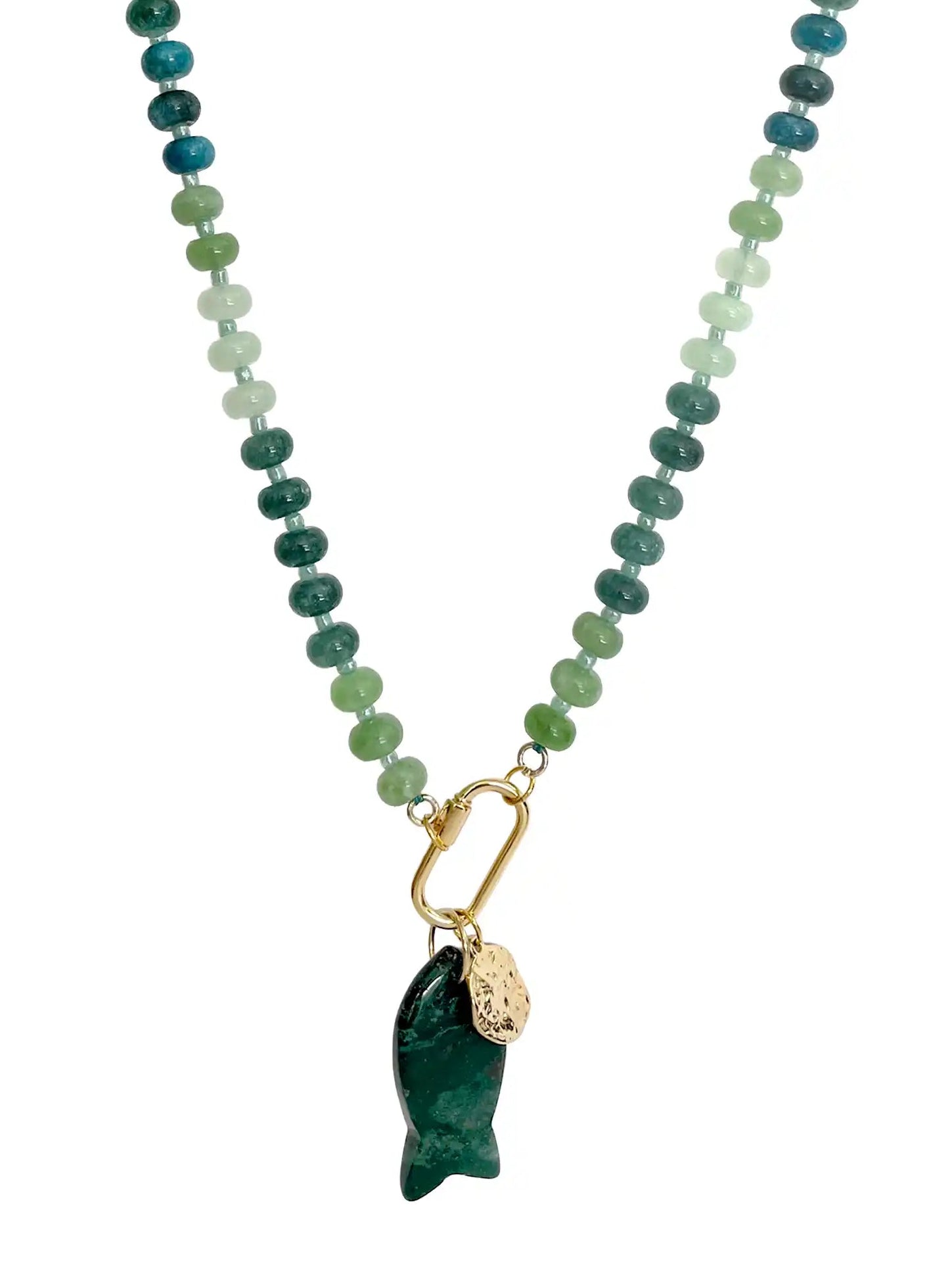 A beaded necklace featuring a gradient of green and blue stones transitioning into light mint green beads, finished with a gold carabiner holding a dark green carved fish pendant and a small gold tag.