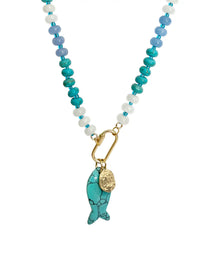 A beaded necklace featuring turquoise, light blue, and white beads with a gold carabiner and a turquoise fish-shaped pendant with a small gold coin charm, set against a plain white background.