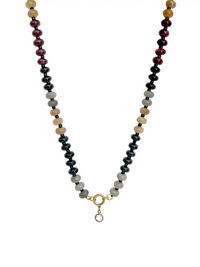 A beaded necklace featuring alternating strands of glossy black, light gray, cream, and deep burgundy beads, finished with a gold-tone ring and a small clear stone drop.