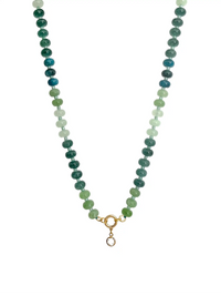 A beaded necklace featuring three vertical strands of round beads in shades of green, teal, and white, finished with a gold ring and a small hanging charm, shown against a plain white background.
