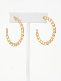 A pair of gold chain-link hoop earrings displayed on a white jewelry stand against a white background.