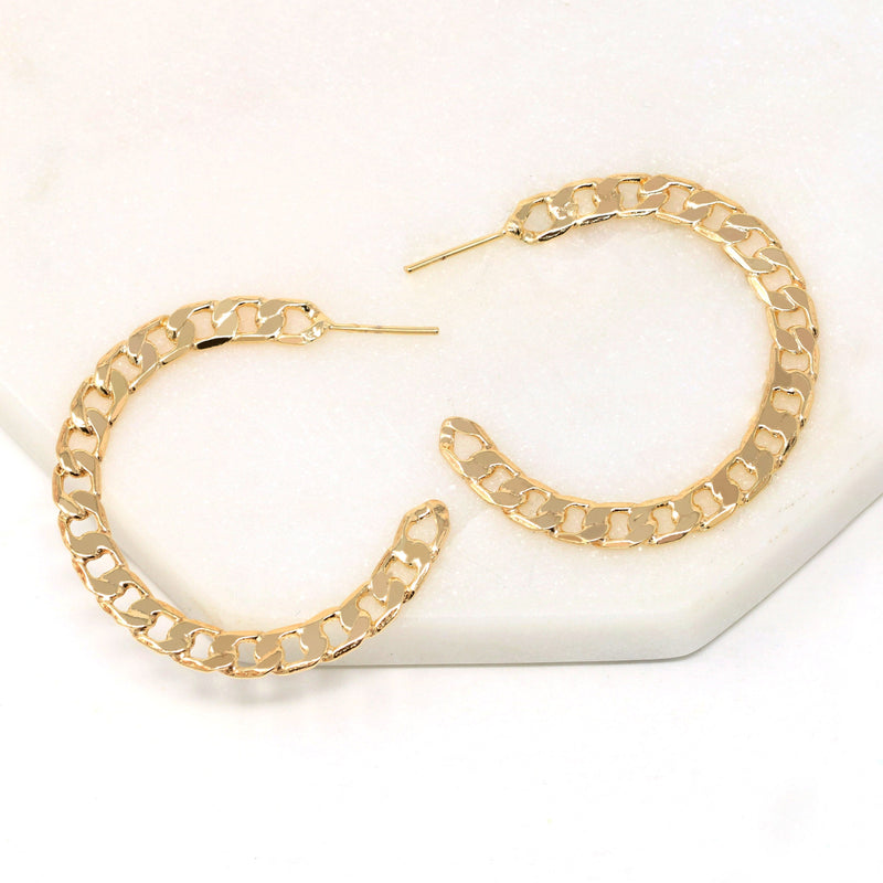 A pair of cuban chain textured hoop earrings made of gold filled.