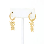 A pair of cute owl drop and dangle earrings in huggie hoop earrings made of gold filled.