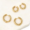 A pair of bold simple hoop huggie earrings made of gold filled.