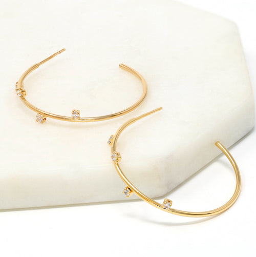 A pair of crystal accented delicate hoop earrings made of gold filled.