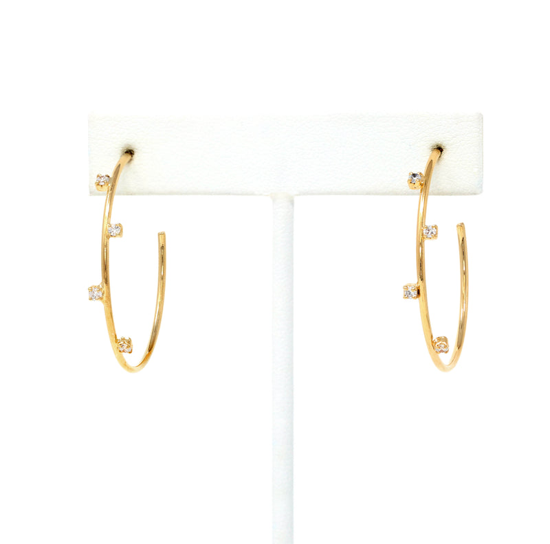 A pair of crystal accented delicate hoop earrings made of gold filled.