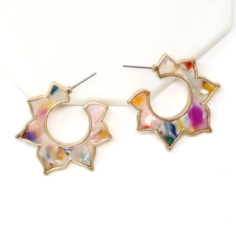 A pair of flower-shaped hoop earrings made of multicolored resin with a gold-tone outline.