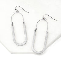 Oval shaped earrings featuring metal drops suspended from silver-plated hooks.
