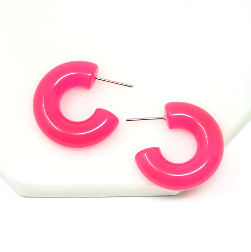 Featuring a pair of minimalist design bold resin hoop earrings crafted with high-quality neon pink colored resin material, adding a pop of color to any outfit.