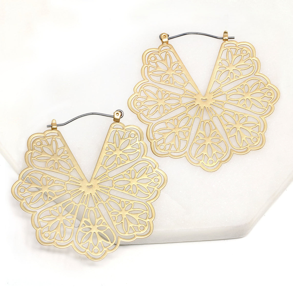 A pair of floral patterned filigree lightweight statement hoop earrings in gold.