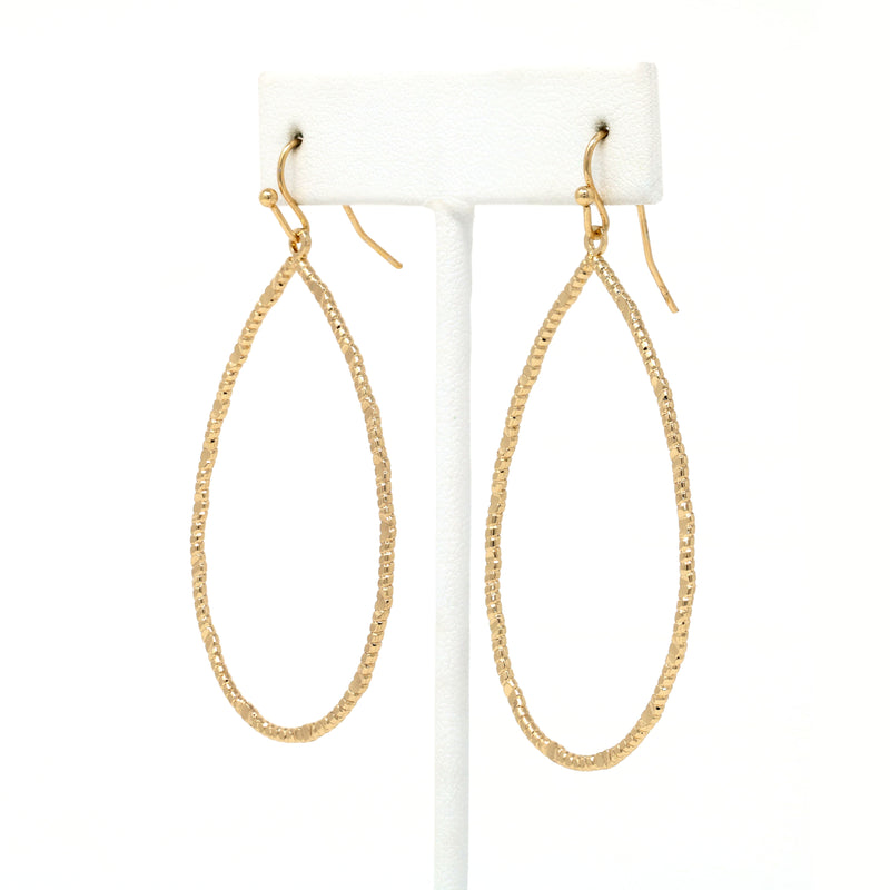 A pair of lightweight teardrop-shaped metal statement earrings. The surface of the earrings is textured, creating a reflective and eye-catching effect. The earrings have a simple and modern design, yet stylish.