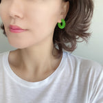 Featuring a pair of minimalist design bold resin hoop earrings crafted with high-quality neon green colored resin material, adding a pop of color to any outfit.