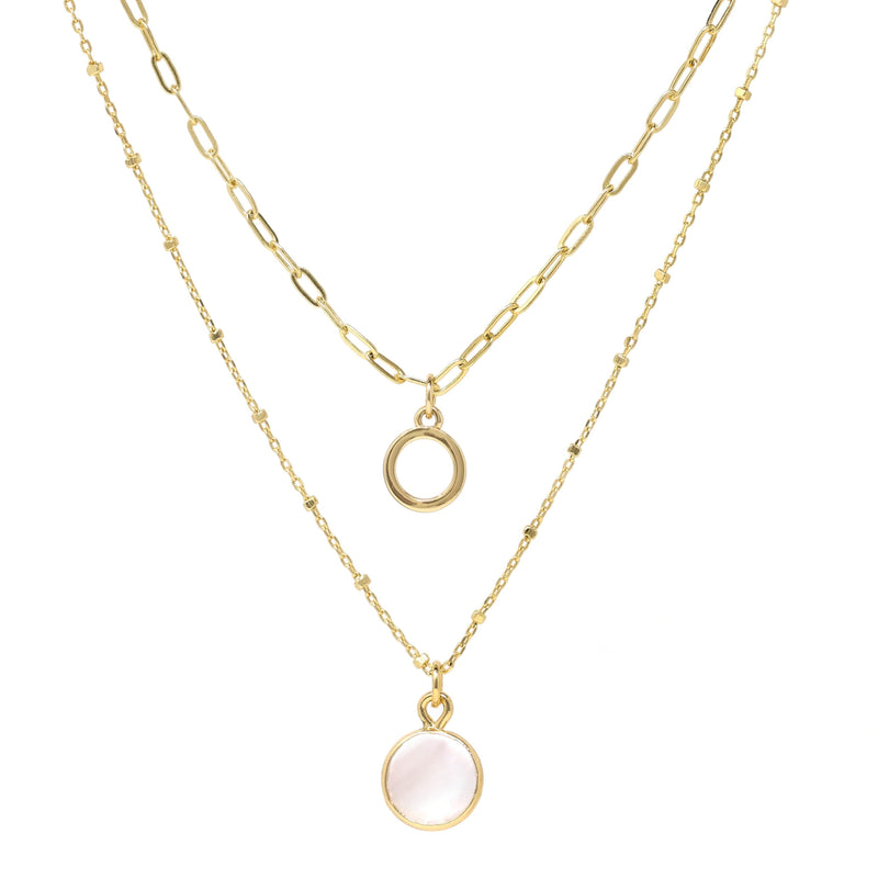 A set of double layer necklace in gold with a small disc and a gold trimmed mother of pearl charm.