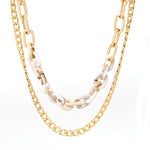 A set of double layered chain necklace mixed with ivory resin link chain.